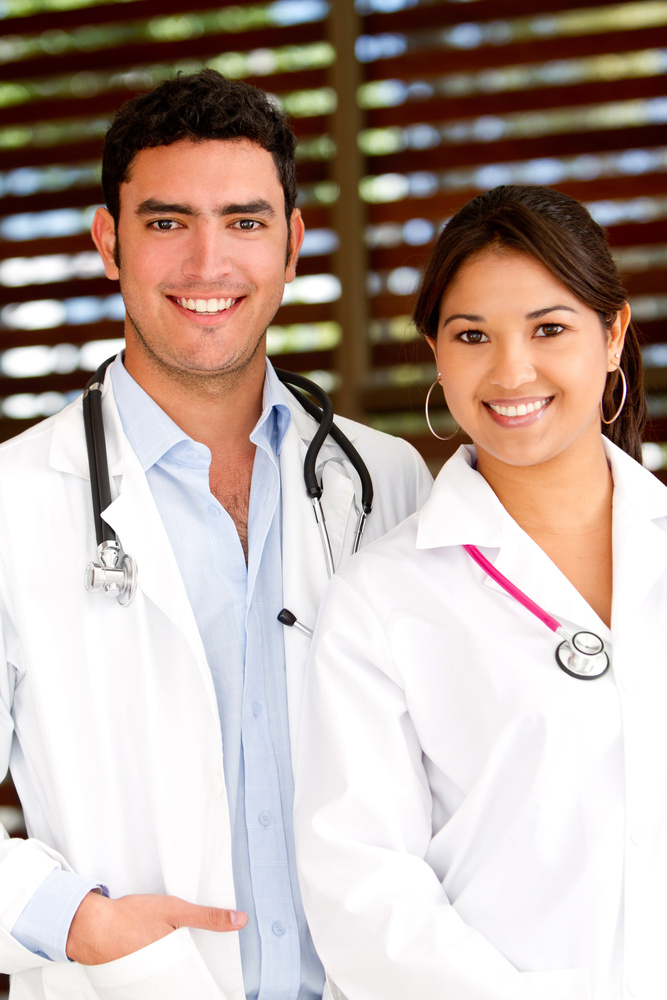 Couple of doctors at the hospital smiling