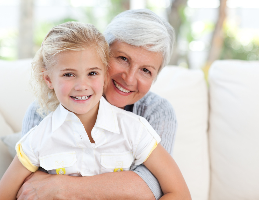 Lovely little girl with her grandmother looking at the camera